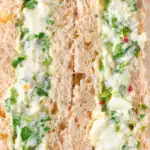 Close-up canned crab sandwich with coriander, lime and chilli mayonnaise on seeded bread.