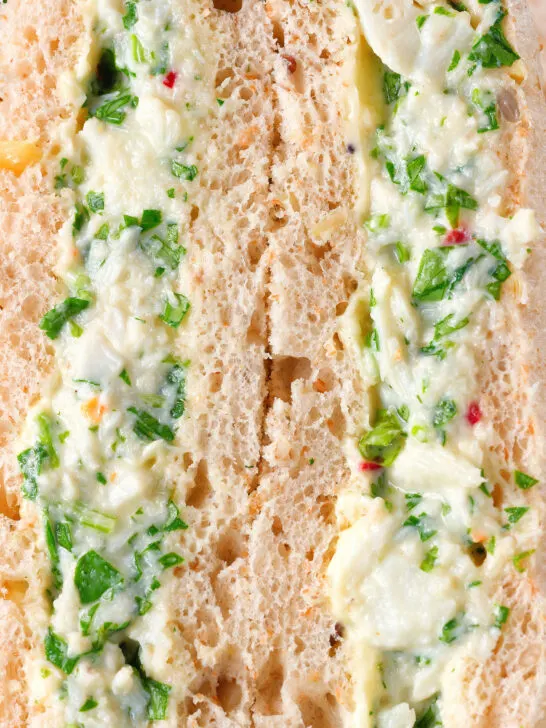 Close-up canned crab sandwich with coriander, lime and chilli mayonnaise on seeded bread.