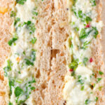 Close-up canned crab sandwich with coriander, lime and chilli mayonnaise on seeded bread.