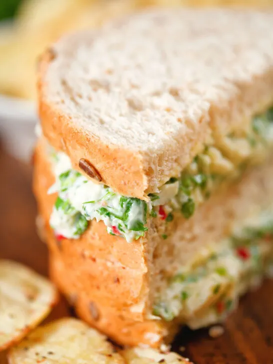 Tinned crab sandwiches with coriander, lime and chilli mayonnaise serve with crisps.
