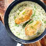 Creamy tarragon chicken breasts in a vermouth sauce in a pan.