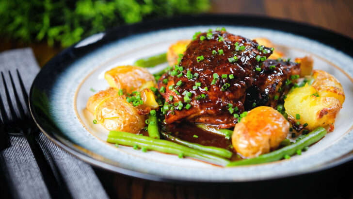 Devilled chicken thighs with roasted crushed new potatoes and green beans.