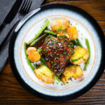 Devilled chicken thighs with roasted crushed new potatoes and green beans.