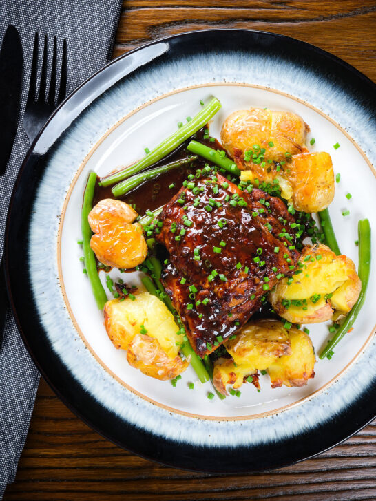 Overhead devilled chicken thighs served with roasted new potatoes, green beans and chives.