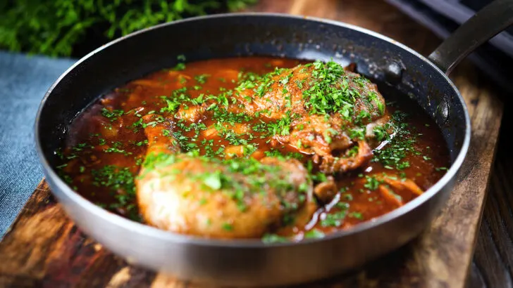 French chicken leg chasseur served in a saute pan.