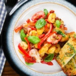 Gnocchi tray bake with sun-dried and fresh tomatoes, mozzarella and chilli served with garlic ciabatta.