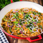Homemade Sri Lankan chicken kottu (kotthu) roti served in a cooking pan.