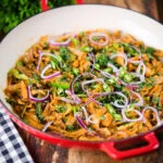 Homemade Sri Lankan chicken kottu (kotthu) roti served in a cooking pan.