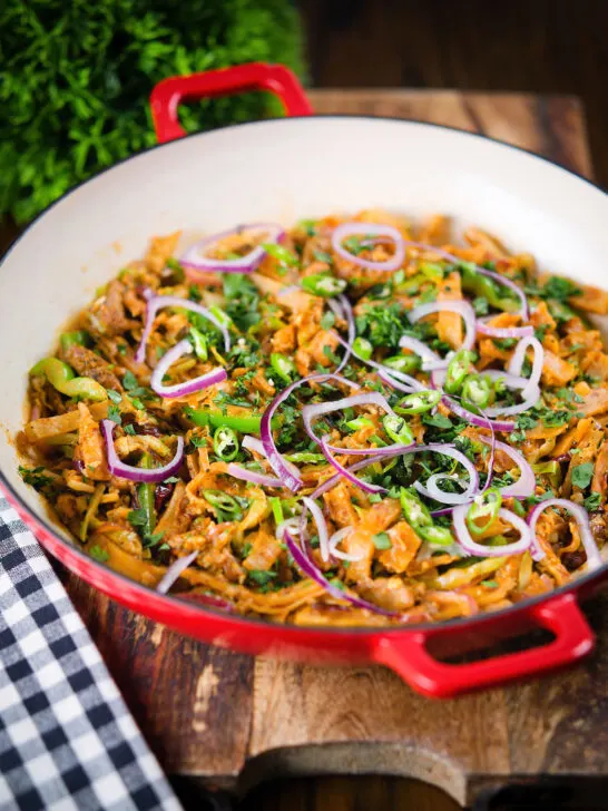 Homemade Sri Lankan chicken kottu (kotthu) roti served in a cooking pan.