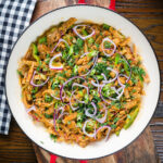 Overhead homemade Sri Lankan chicken kottu (kotthu) roti served in a cooking pan.
