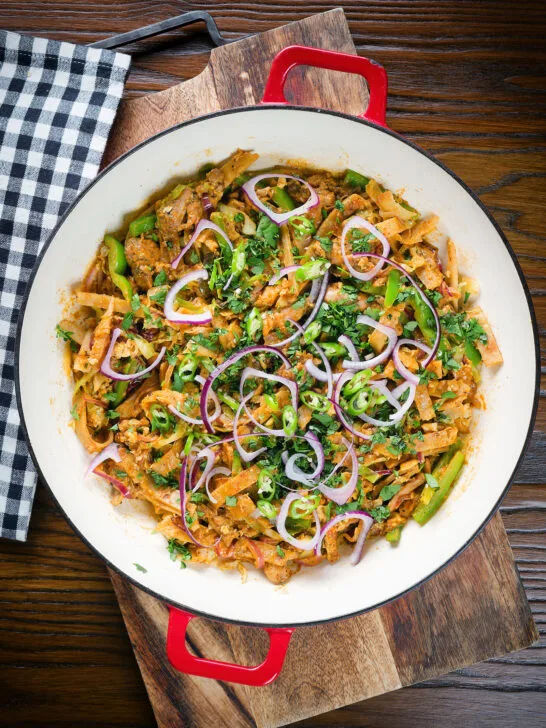 Overhead homemade Sri Lankan chicken kottu (kotthu) roti served in a cooking pan.
