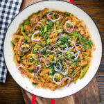 Overhead homemade Sri Lankan chicken kottu (kotthu) roti served in a cooking pan.
