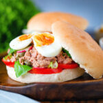 Pan bagnat (French tuna sandwich) with tomatoes, boiled egg and capers.