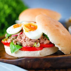 Pan bagnat (French tuna sandwich) with tomatoes, boiled egg and capers.