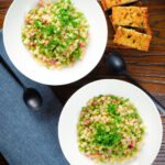 Overhead Italian pasta e piselli with peas, pancetta, mint and ditalini served with garlic ciabatta.