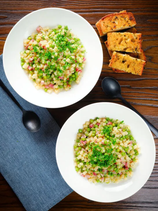 Overhead Italian pasta e piselli with peas, pancetta, mint and ditalini served with garlic ciabatta.