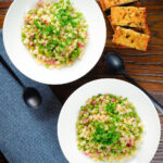 Overhead Italian pasta e piselli with peas, pancetta, mint and ditalini served with garlic ciabatta.