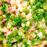 Close-up overhead Italian pasta e piselli with peas, pancetta, mint, parsley and ditalini.