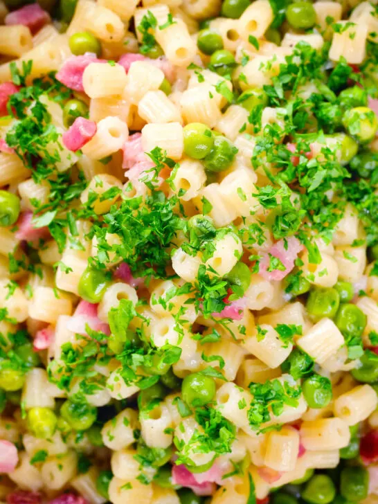Close-up overhead Italian pasta e piselli with peas, pancetta, mint, parsley and ditalini.