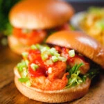 King prawn sandwich with a bloody Mary sauce and celery on a brioche bun with the lid off.