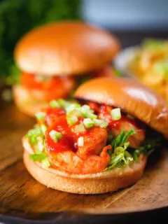 King prawn sandwich with a bloody Mary sauce and celery on a brioche bun with the lid off.