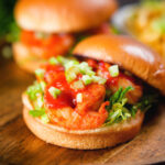 King prawn sandwich with a bloody Mary sauce and celery on a brioche bun with the lid off.