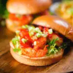 King prawn sandwich with a bloody Mary sauce and celery on a brioche bun with the lid off.