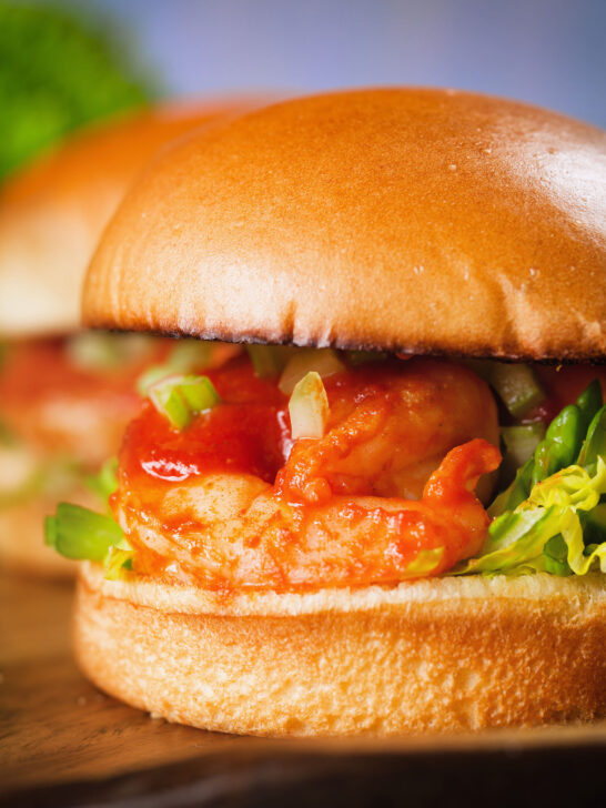 Close-up King prawn sandwich with a bloody Mary sauce and celery on a brioche bun.