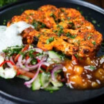 Roasted tandoori cauliflower steak with kachumber salad, mango chutney and mint raita.
