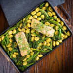 Salmon fillet traybake with gnocchi, basil pesto, asparagus, sugar snap peas and broccoli.