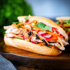 Vietnamese chicken banh mi sandwich with pickles on a French baguette.