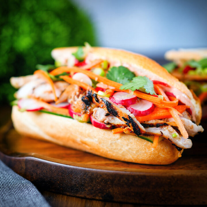 Vietnamese chicken banh mi sandwich with pickles on a French baguette.