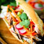 Vietnamese-influenced chicken banh mi sandwiches on a French baguette.
