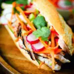 Vietnamese-influenced chicken banh mi sandwiches on a French baguette.