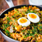 Anglo-Indian smoked mackerel kedgeree (rice) served with boiled egg in a cooking pan.