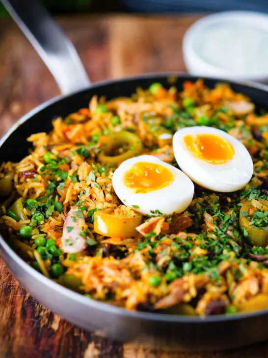 Anglo-Indian smoked mackerel kedgeree (rice) served with boiled egg in a cooking pan.