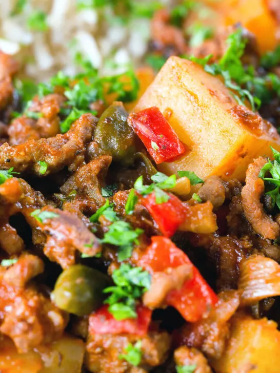Close-up Cuban inspired minced beef picadillo with potatoes, raisins, capers and brown rice.