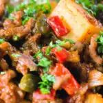 Close-up Cuban inspired minced beef picadillo with potatoes, raisins, capers and brown rice.