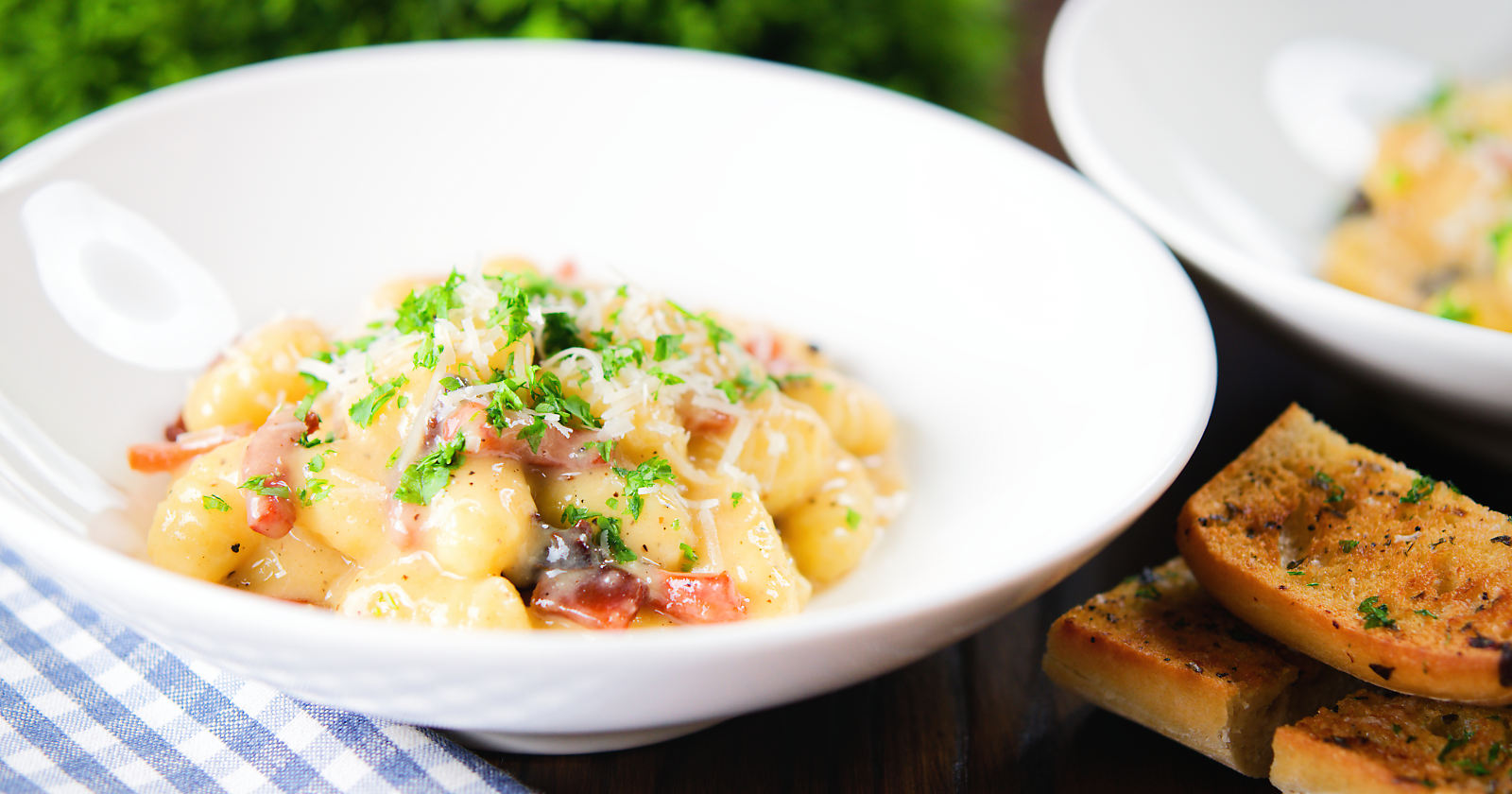 Rich and creamy gnocchi carbonara with pecorino cheese and fresh parsley served with garlic bread.