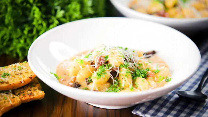 Rich and creamy gnocchi carbonara with pecorino cheese and fresh parsley served with garlic bread.