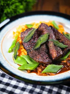 Pan fried calves liver an onion and bacon gravy, swede and carrot mash, beans and sage.