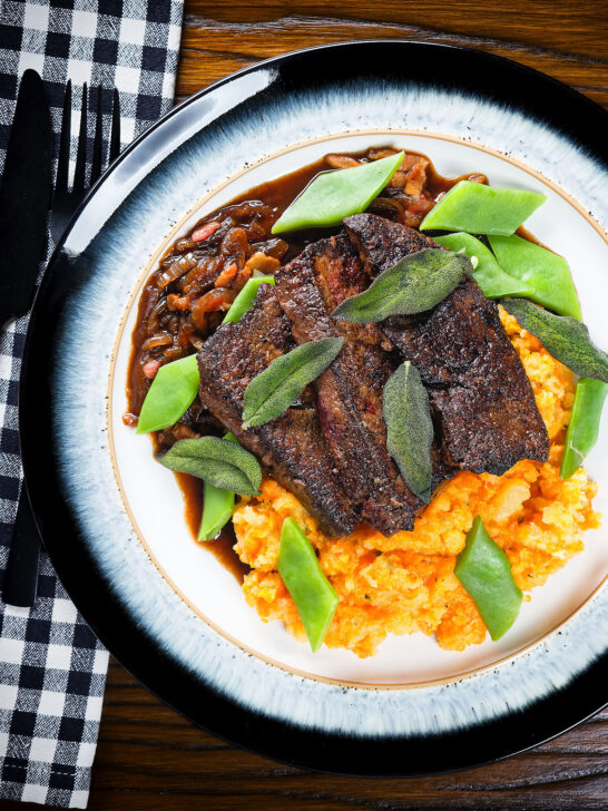Overhead pan fried calves liver an onion and bacon gravy, swede and carrot mash, beans and sage.