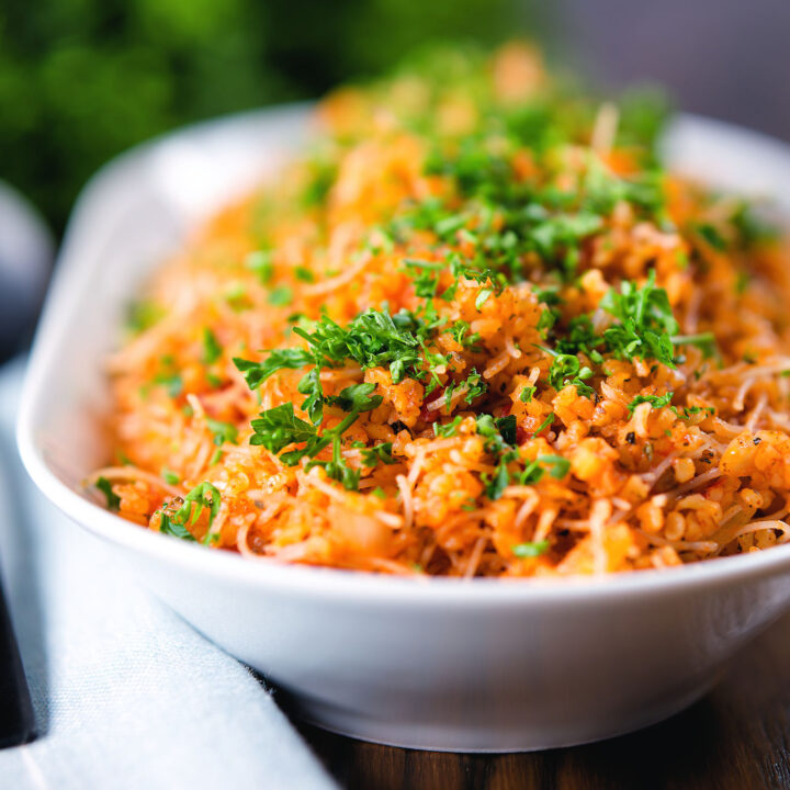 Pourgouri a bulgur and vermicelli noodle pilaf garnished with fresh parsley.