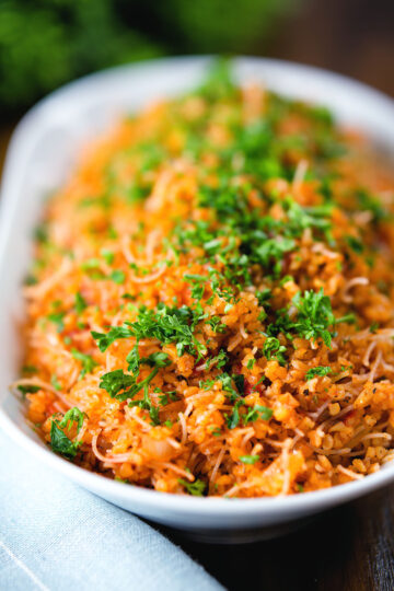 Pourgouri Cypriot/Greek bulgur and vermicelli noodle pilaf garnished with fresh parsley.