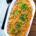 Overhead pourgouri Cypriot/Greek bulgur and vermicelli noodle pilaf garnished with fresh parsley.