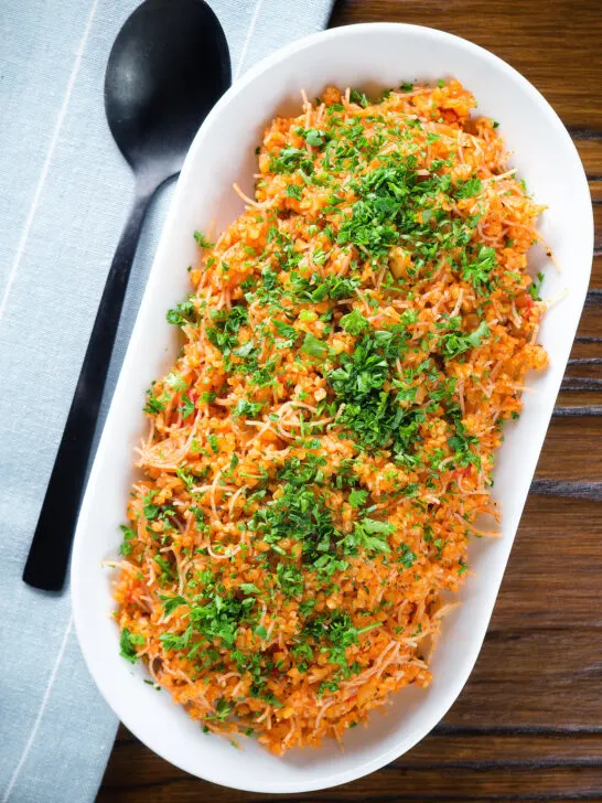 Overhead pourgouri Cypriot/Greek bulgur and vermicelli noodle pilaf garnished with fresh parsley.