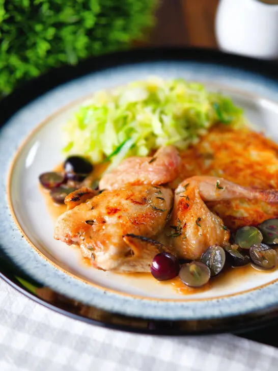 Roast spatchcock quail with Marsala and black grape sauce, buttered cabbage and potato rosti.