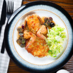 Overhead roast spatchcock quail with Marsala and black grape sauce, buttered cabbage and potato rosti.