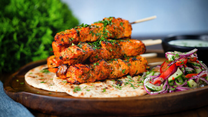 Indian salmon tikka kebabs served with roti, kachumber salad and raita.