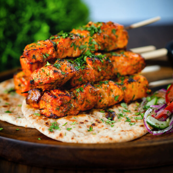 Indian salmon tikka kebabs served with roti, kachumber salad and raita.